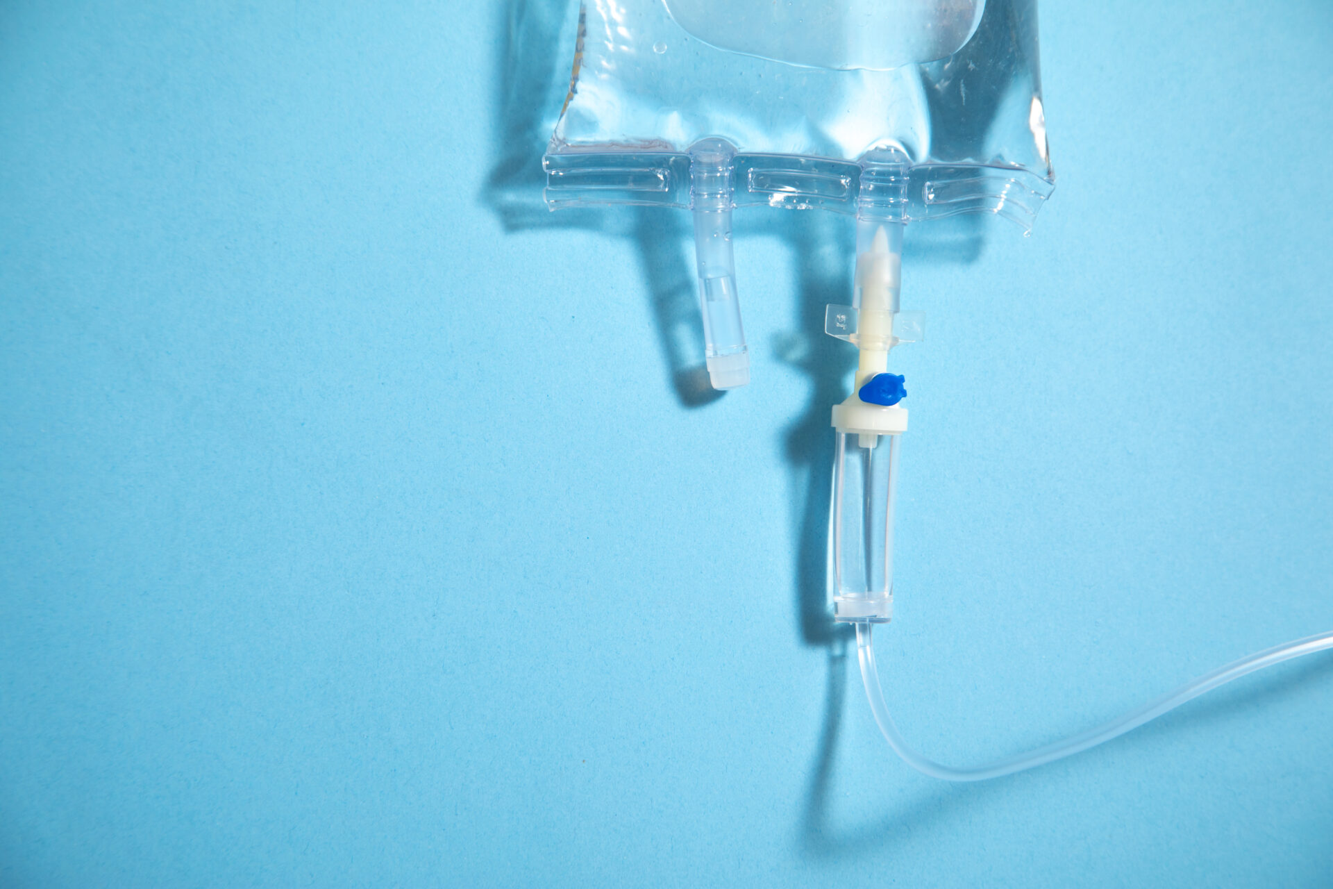 Infusion Bag In The Blue Background. Iv Drip Chamber